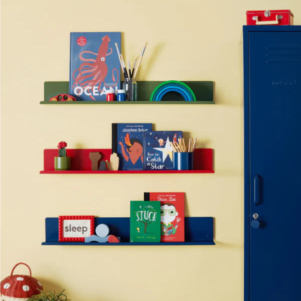 Colorful shelves with books and toys against a yellow wall, next to a blue locker.