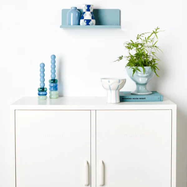 White cabinet and light blue shelf and decor