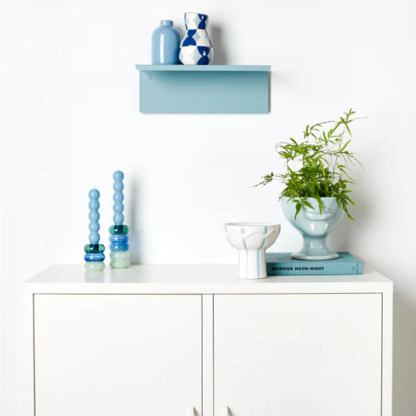White cabinet and light blue shelf and decor