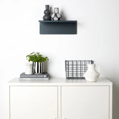 White cabinet with decorative items including a plant, vases, and a basket on a white background
