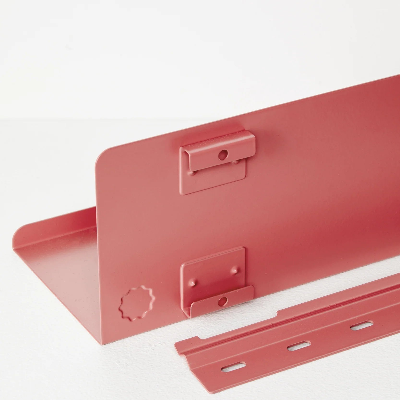 Red metal bracket on a white background