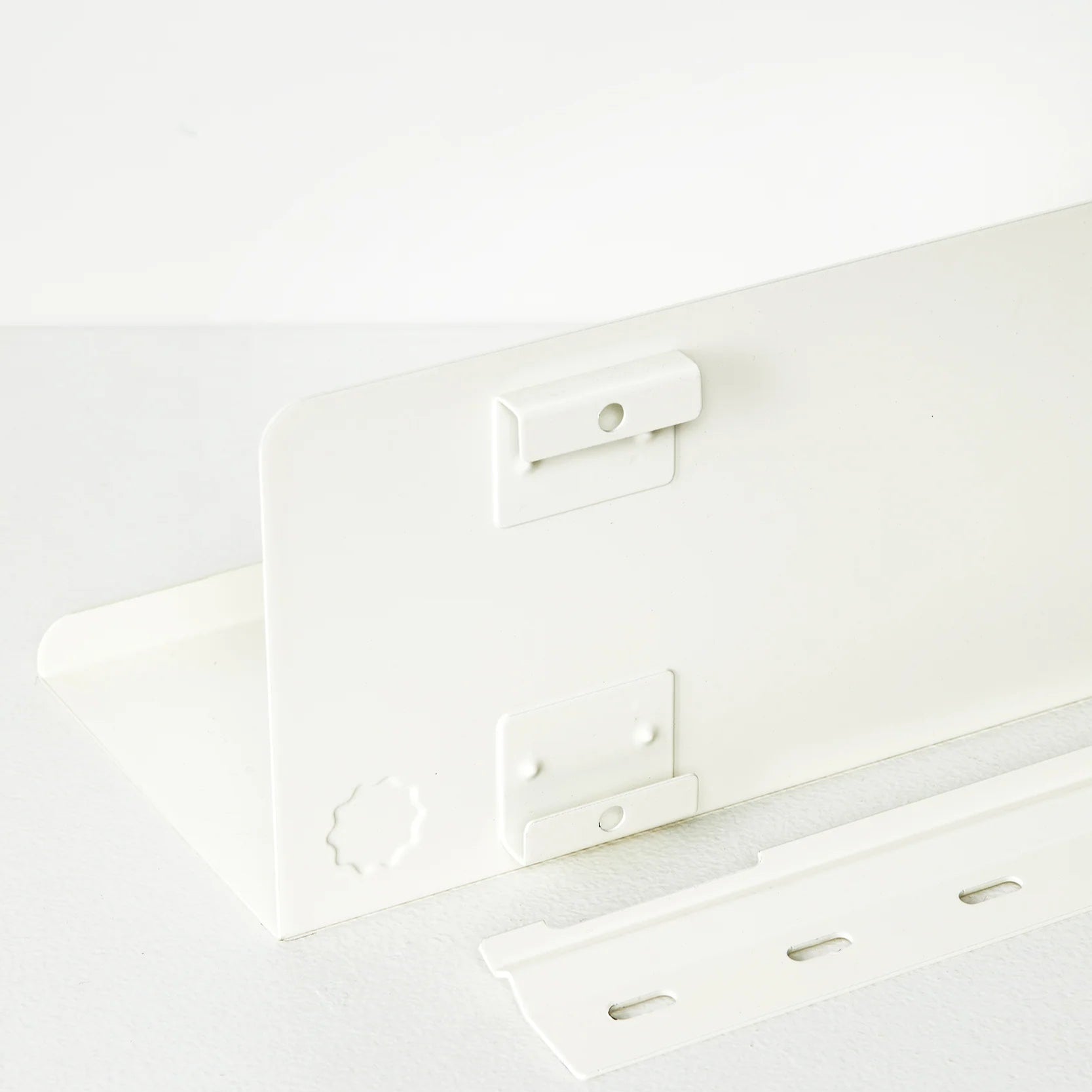 Back of a white shelf 