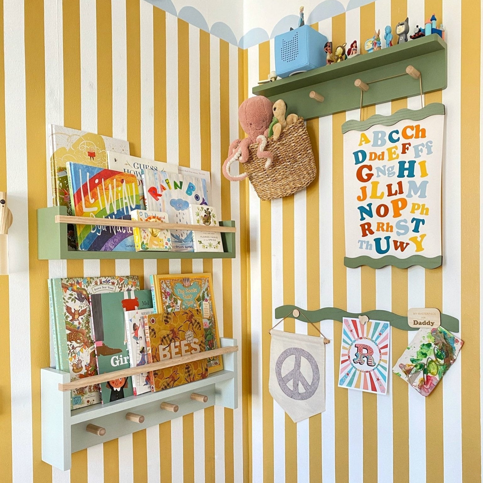 Children's room with striped walls, shelves with books and toys, and colorful alphabet chart.