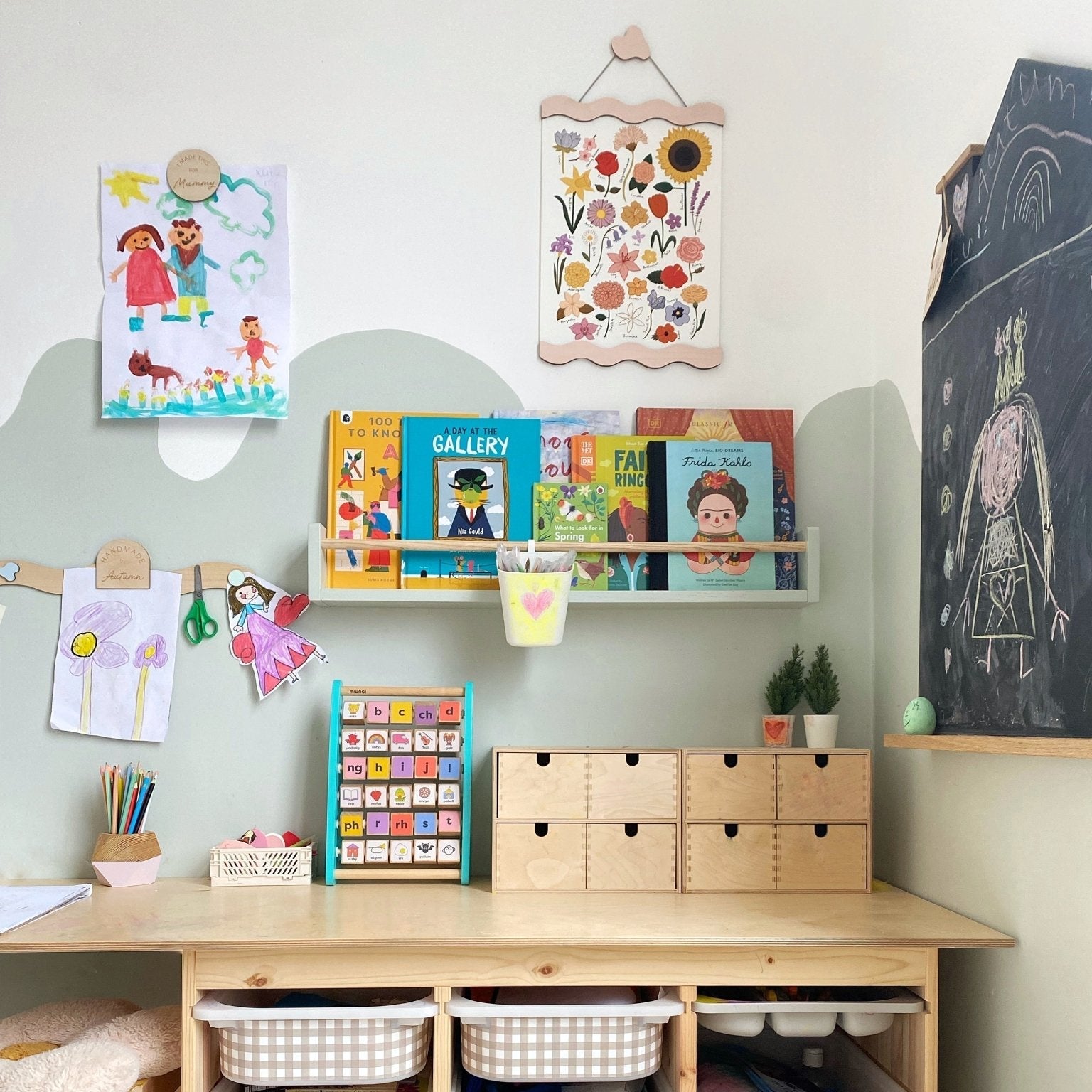 Children's room with a desk, storage bins, and educational materials.